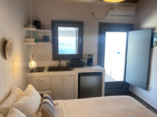 a kitchen with a couch and a sink in a room at Studios Betty in Plaka Milou