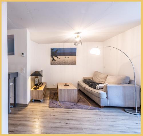 a living room with a couch and a table at Maison en Duplex I Yvoire I Lac Léman I Médiévale in Yvoire