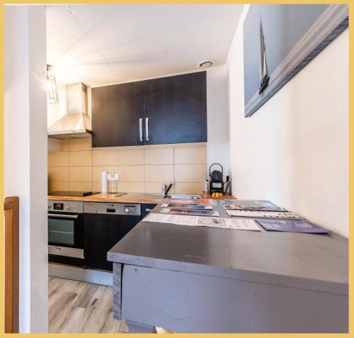 a kitchen with a stove and a counter top at Maison en Duplex I Yvoire I Lac Léman I Médiévale in Yvoire