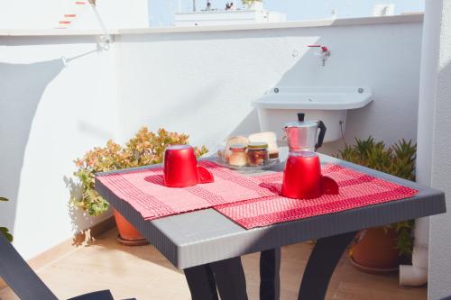 ポリニャーノ・ア・マーレにあるCasa Viola -Locazione Breveの赤いテーブルクロスを掛けたテーブル