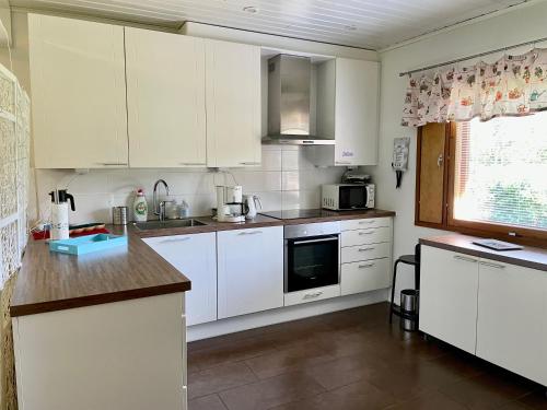 a kitchen with white cabinets and a counter top at Villa Salir - bedroom, kitchen and bathroom 
