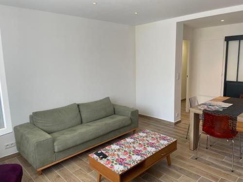 a living room with a couch and a table at La Serane Appartement T3 in Marseille