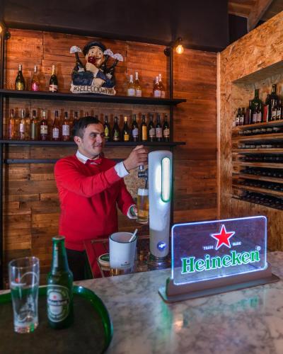 a man standing behind a bar with a bartender at Djerba Holiday Beach in Midoun