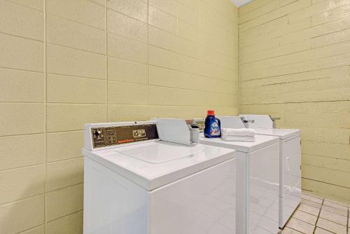 a laundry room with two washing machines and a sink at Super 8 by Wyndham Indianapolis South in Indianapolis