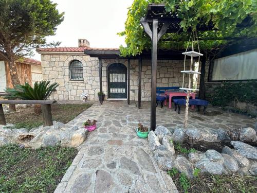 a garden with a stone patio with a table at sweet horses ST6 in Didim