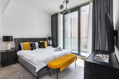 a bedroom with a bed and a large window at Vivid 2-bedroom Marina view in Dubai