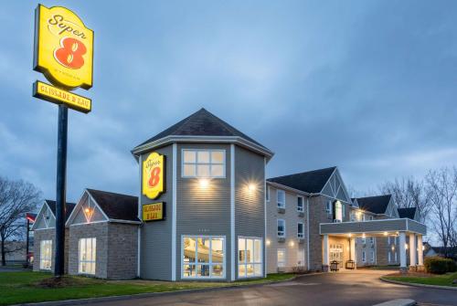 a fast food restaurant with a sign in front of it at Super 8 by Wyndham Trois-Rivieres in Trois-Rivières