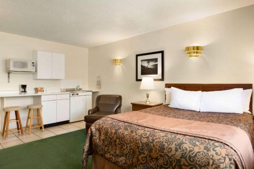 a hotel room with a bed and a kitchen at Travelodge by Wyndham Simcoe in Simcoe