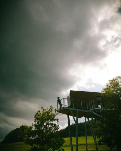 a person standing on top of a lifeguard tower at Walden House Casarampi in Orsano
