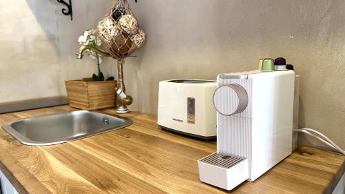 a microwave sitting on a counter next to a sink at Boutique apartment in heart of Haifa in Haifa