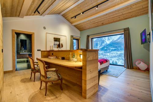 a bedroom with a desk and a bed and a window at Le Chalet Mont Blanc in Les Houches