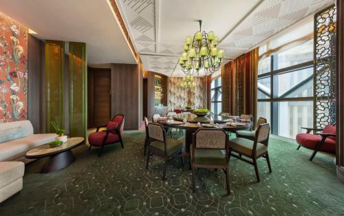 a dining room with a table and chairs and a couch at Andaz Singapore, By Hyatt in Singapore