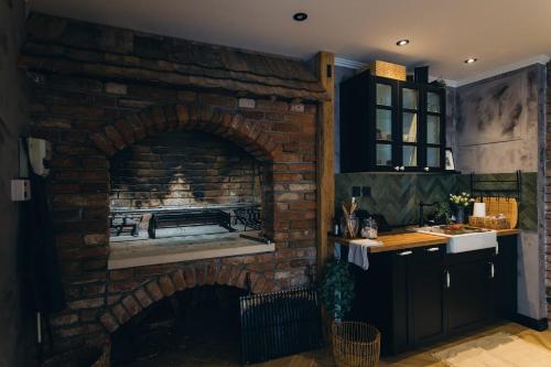 a brick fireplace in a kitchen with a stove at Apartment Lara in Senj
