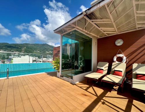 a house with a deck with a view of the water at Centro One Bangla in Patong Beach