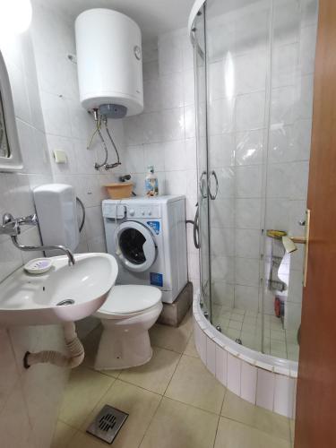 a bathroom with a toilet sink and a shower at Первая линия. У моря. in Muo