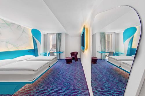 a hotel room with two beds and blue carpet at Prize by Radisson, Hamburg St Pauli in Hamburg