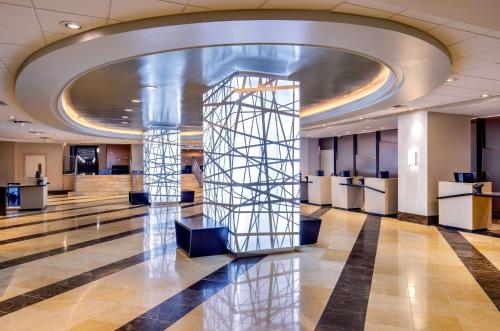 a lobby of a building with a large ceiling at Courtland Grand Hotel, Trademark Collection by Wyndham former Sheraton Atlanta in Atlanta