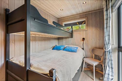 a bedroom with a bunk bed in a tiny house at Beachfront Paradise Lofoten in Bøstad
