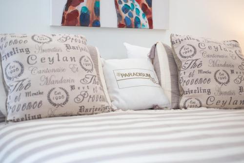 a white bed with pillows on top of it at STUDIO apartment near Seven Mile Beach at The Grove in Upper Land