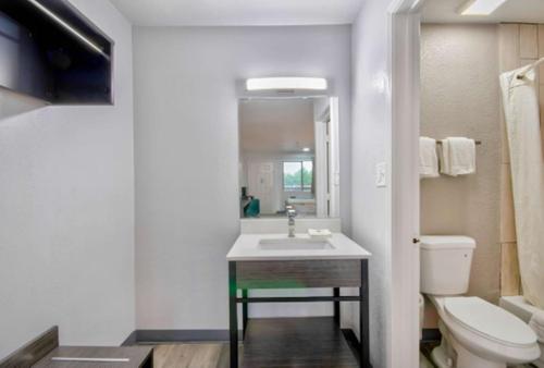 a bathroom with a sink and a toilet at Motel 6 Texarkana, TX in Texarkana