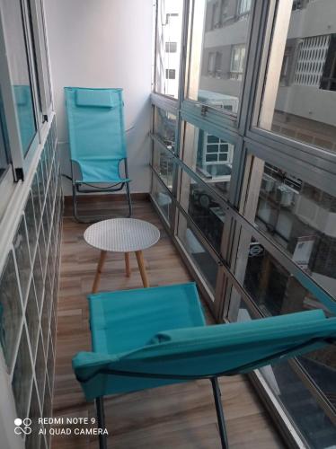 a balcony with two chairs and a table at Raquel Apartament in Alicante