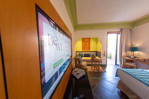 a living room with a flat screen tv on a wall at Jaal Riad Resort in Marrakech