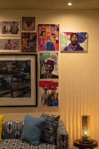 a living room with a couch and pictures on the wall at Jaal Riad Resort in Marrakech