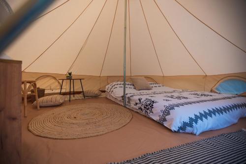 a room with a bed in a tent at Glamping La Octav in Tîrpeşti