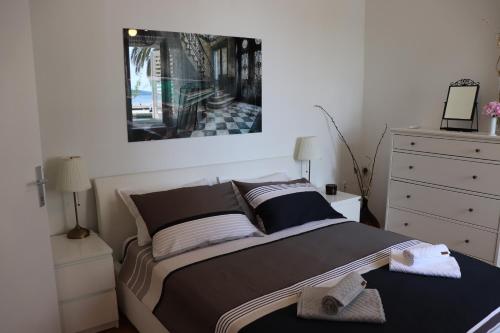 a bedroom with a bed with a picture on the wall at Luxury apartment Lukas in Orebić