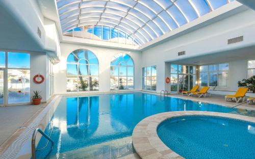 a large swimming pool with a glass ceiling at Djerba Holiday Beach in Midoun