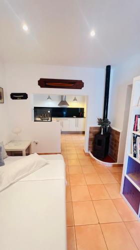 a living room with a bed and a fireplace at Casa Nena Es Calo in Es Caló