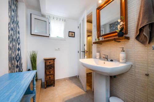 La salle de bains est pourvue d'un lavabo et d'un miroir. dans l'établissement Cel Pins, à Portopetro