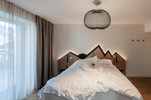 Postel nebo postele na pokoji v ubytování Alpin & Stylehotel Die Sonne
