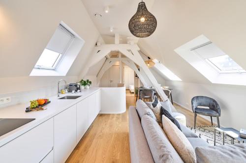 a kitchen and living room with skylights at Place du Grand Sablon in Brussels