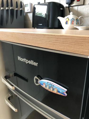 a black microwave oven with a counter on top of it at Beach House in Filey