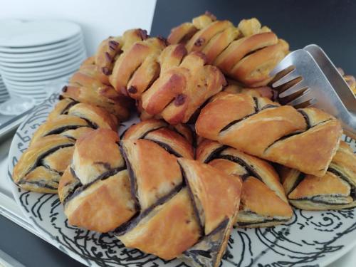 a plate of pastries on a table with a fork at Hotel Miramare in Marina di Ragusa