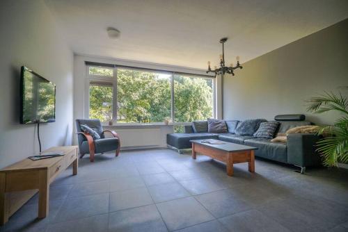 a living room with a couch and a table at CityHouse Alkmaar in Alkmaar