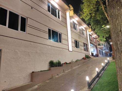 a building with lights on the side of a street at Beverly villa in Ooty
