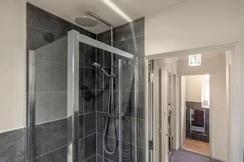 een badkamer met een douche en een glazen deur bij 4 bedroom Pitchford in Earlham