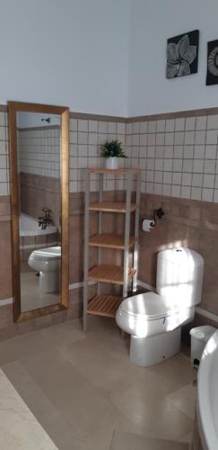 uma casa de banho com WC, 2 lavatórios e um espelho. em VILLA LA MARISMA em Chiclana de la Frontera