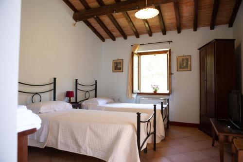 Postel nebo postele na pokoji v ubytování Agriturismo I Melograni