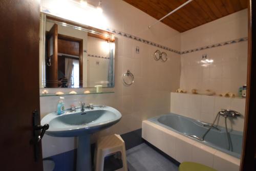 a bathroom with a sink and a bath tub at Jeannet's Beach House in Amarynthos