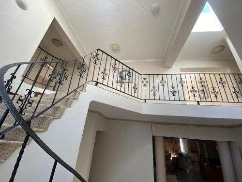 a spiral staircase in a building with a window at Siena Sun Guesthouse Rooms and Breakfast Option in Midrand