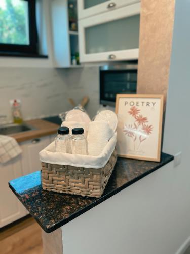 a counter top with a basket of towels and a bag at Cozy Glen - Private Villa, Parking and BBQ in Târgu-Mureş