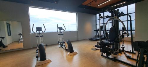 a gym with tread machines in a room with a large window at LeR Homes in Nairobi