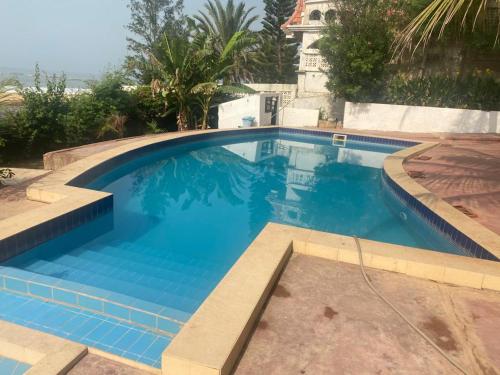 a large swimming pool with blue water at Yannick House in Nditarh