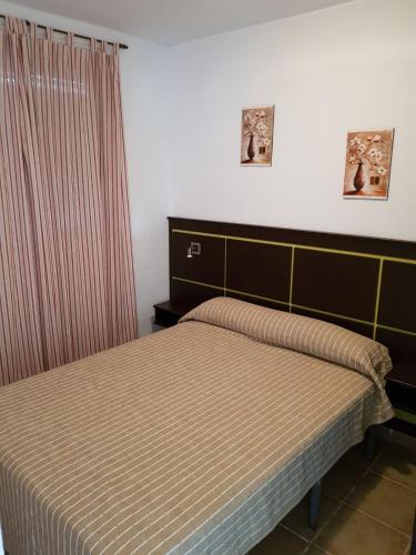 A bed or beds in a room at Urbanización las Torres Apartamento