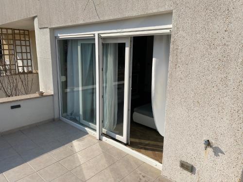 an open sliding glass door on a building at Rab,new Apartman in Rab