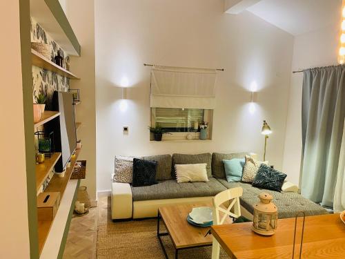 a living room with a couch and a table at Rab,new Apartman in Rab