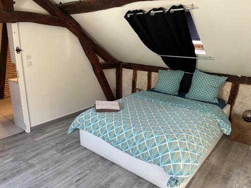 a bedroom with a bed with a black curtain at les Pastoureaux in Orléans